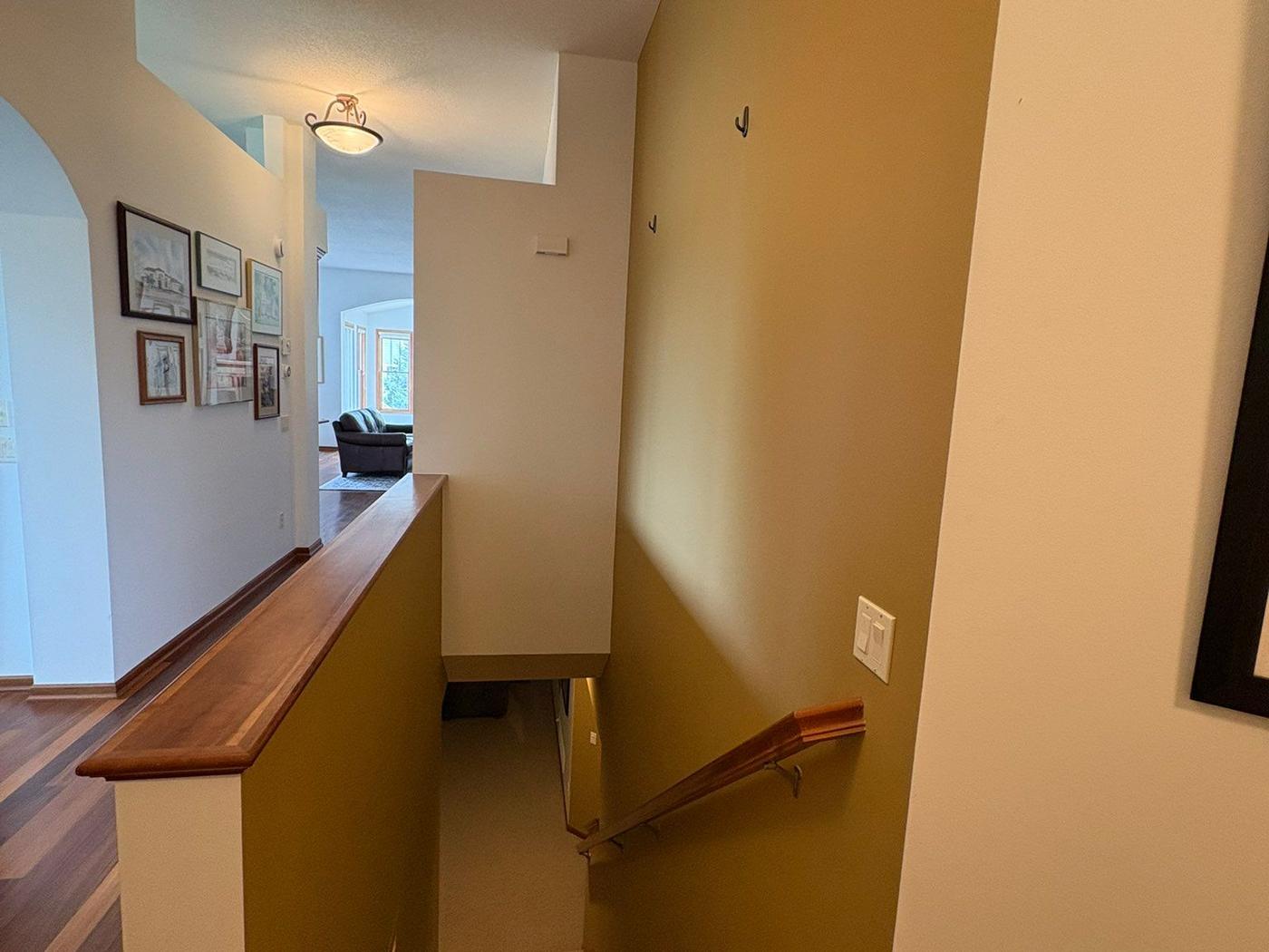 Stairwell with mustard yellow walls before painting